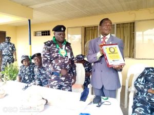 Group coordinator Mr Efe-Khaese Osano while presenting the award to the DPO, CSP Mukhtari Bello