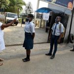 A health worker checks the temperature with an infrared thermometer of students queueing and keeping distances on resumption of studies at Access International Schools, in Magboro, Ogun State, southwest Nigeria, on Aug. 4, 2020. PHOTO BY PIUS UTOMI EKPEI/AFP VIA GETTY IMAGES