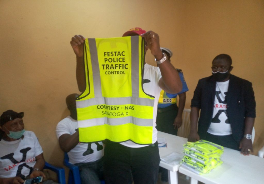 Chukwuma displaying a sample of the reflective jacket during the visit_1601892873059