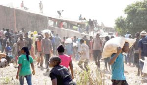 Some-youths-carrying-looted-bags-of-food-palliatives-after-they-broke-into-Plateau-government-warehouse-in-Jos-yesterday