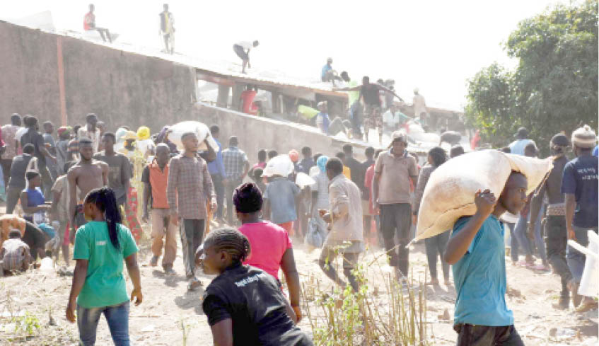 Some-youths-carrying-looted-bags-of-food-palliatives-after-they-broke-into-Plateau-government-warehouse-in-Jos-yesterday