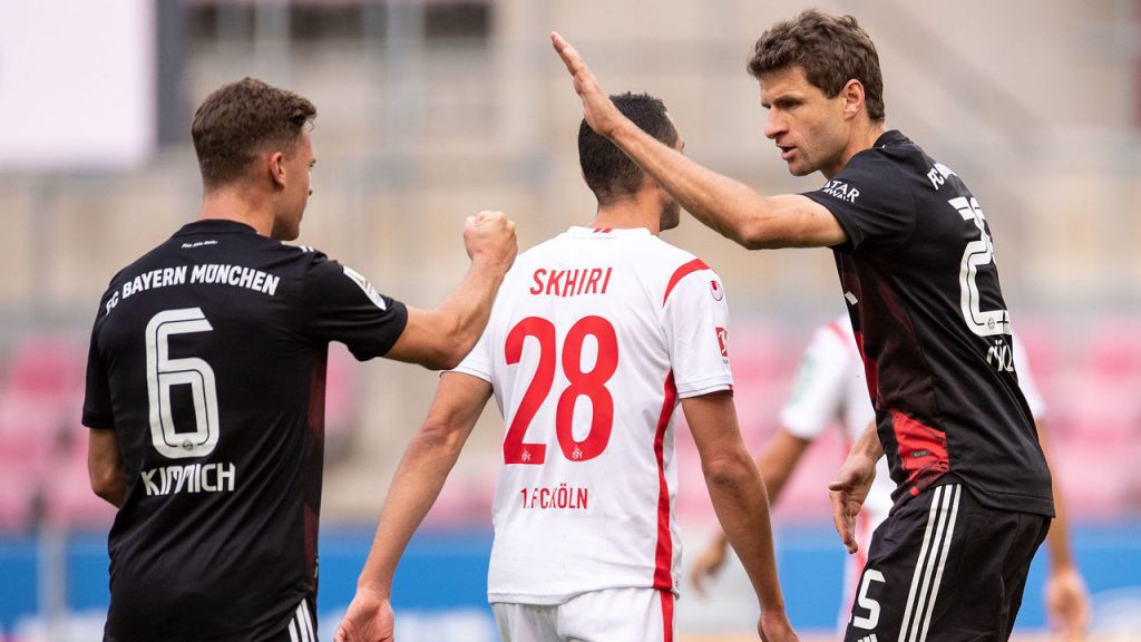 Mueller (R) celebrates converting his first-half penalty Marius Becker POOL/AFP