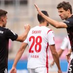 Mueller (R) celebrates converting his first-half penalty Marius Becker POOL/AFP