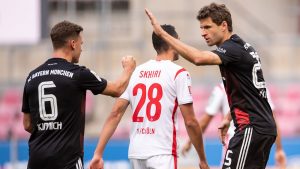 Mueller (R) celebrates converting his first-half penalty Marius Becker POOL/AFP