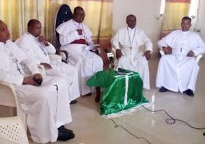 Bishop Onuagha (middle) and his priests