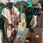 Second Left: Village Head M Musa handing over a package to disabled elder M Inuwa