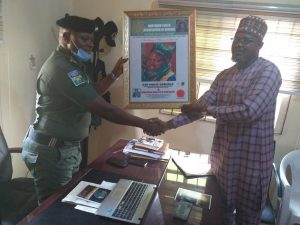 The Sector Commander, Inspector General of Police (IGP) Special Task Force on Petroleum and Illegal Bunkering, Warri, CSP Philip Gomerep, being handed over the award of recognition by National President of Northern Youths Association of Nigeria, Comrade Godiya Bogoro, in Warri