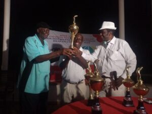 Tournament’s overall winner, Ben Okoko, receives his trophy from Angelo Elosia, the Chairman/Chief Coordinator of the Save The Lives Charity Golf Tournament, and IBM Haruna, the Chairman, Board of Trustees, IBB International Golf and Country Club In Abuja on Saturday