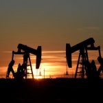 FILE PHOTO: Pump jacks operate at sunset in an oil field in Midland