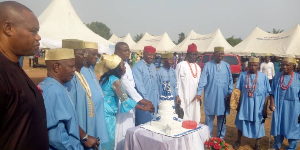 The celebrating octogenarians cutting their birthday cake