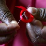 Woman Sewing AIDS SDay Ribbon 07232019_0