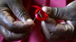 Woman Sewing AIDS SDay Ribbon 07232019_0