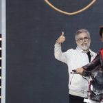 Dr. Munjal {left} presenting one of the Hero motorccycle celebration models at the event