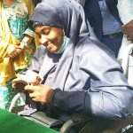A beneficiary, Mariam Abubakar, confirming her N20,000 cash grant in Kaduna on Wednesday  (Photo credit: Sola Ojo)