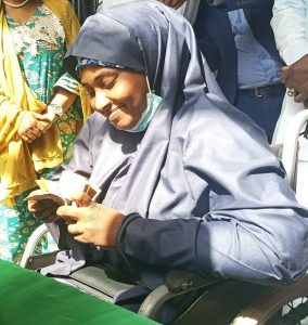 A beneficiary, Mariam Abubakar, confirming her N20,000 cash grant in Kaduna on Wednesday  (Photo credit: Sola Ojo)
