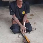 An arrested armed robber being interrogated