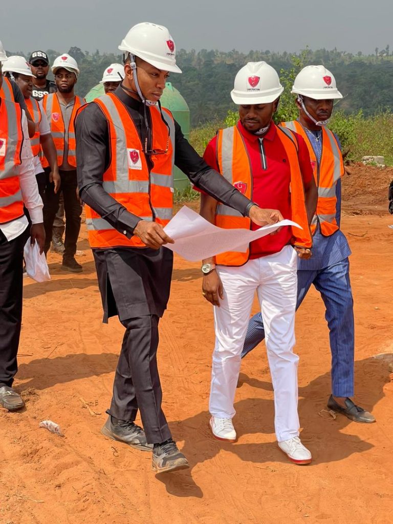 Chairman, GSS Group, Arc. Chukwudi Ezenwa showing the building plan to Commissioner for Lands, Anambra State, Bonaventure Enemal