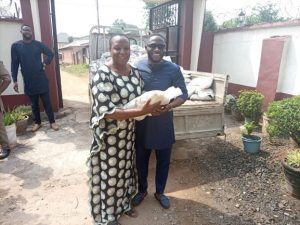 Chibueze Ezenagu handing over the bags of rice to the Chairperson of Umuogbu Women, Mrs Ngozi Ozoemene