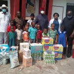 Moghalu {midlle} during the visit to a motherless babies’ home in Onitsha