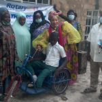 Jane Egbo presenting wheelchair to Mohammed