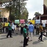 Members of SSANU and NASU University of Lagos branch protesting in front of the main gate