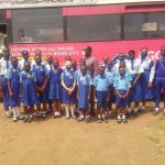 School children queuing beside the bus during the launch of the programme in Benin City