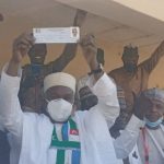 Ambassador Yusuf Tuggar displaying his membership card after his revalidation. Photo credit- Armstrong Bakam