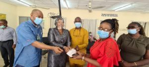 LAMATA Director, Rail Transportation, Engr Olasunkanmi Okusaga, Director of Admin and Human Resource, Nigeria Rail Corporation, Dr Monsurat Omotayo, Regional Manager Lagos District, Engr Jerry Oche presenting a cheque to one of the affected persons
