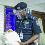 Commissioner of Police Lagos State Mr Hakeem Odumosu with the rescued abandoned baby at Police Command, Ikeja