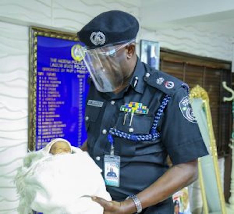Commissioner of Police Lagos State Mr Hakeem Odumosu with the rescued abandoned baby at Police Command, Ikeja