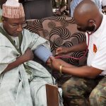 CMD, 44NARH Kaduna, Col A Omogbethai, conducting a blood pressure of the Sarki Badiko, Usman Sani, in Kaduna on Saturday, March 27, 2021