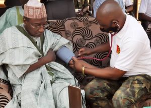 CMD, 44NARH Kaduna, Col A Omogbethai, conducting a blood pressure of the Sarki Badiko, Usman Sani, in Kaduna on Saturday, March 27, 2021