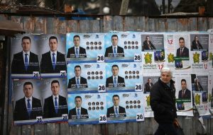 Woman walks past election posters of the ruling centre-right GERB party in the town of Dupnitsa
