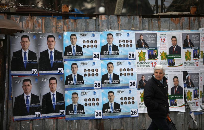 Woman walks past election posters of the ruling centre-right GERB party in the town of Dupnitsa