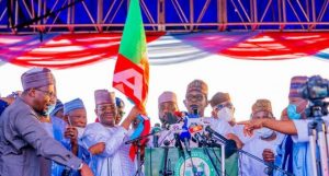 Zamfara Governor Bello Matawalle (holding APC flag), APC National Chairman, Caretaker/Extraordinary Convention Planning Committee of our party, the APC, Governor Mai Mala Buni (centre, speaking)