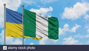 ukraine-and-nigeria-flag-waving-in-the-wind-against-white-cloudy-blue-sky-together-diplomacy-concept-international-relations-2ADPW4M