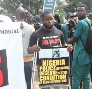 One of last year’s EndSARS protest victims Stephen Asekhame at the anniversary protest in Benin