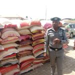 The Area Controller, Ogun Area 1/Command of the Nigeria Customs Service, Dera Nnadi, showing the some of the seized foreign parboiled rice to newsmen