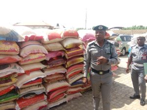The Area Controller, Ogun Area 1/Command of the Nigeria Customs Service, Dera Nnadi, showing the some of the seized foreign parboiled rice to newsmen