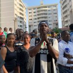People gather at the site of a collapsed building in Ikoyi, Lagos