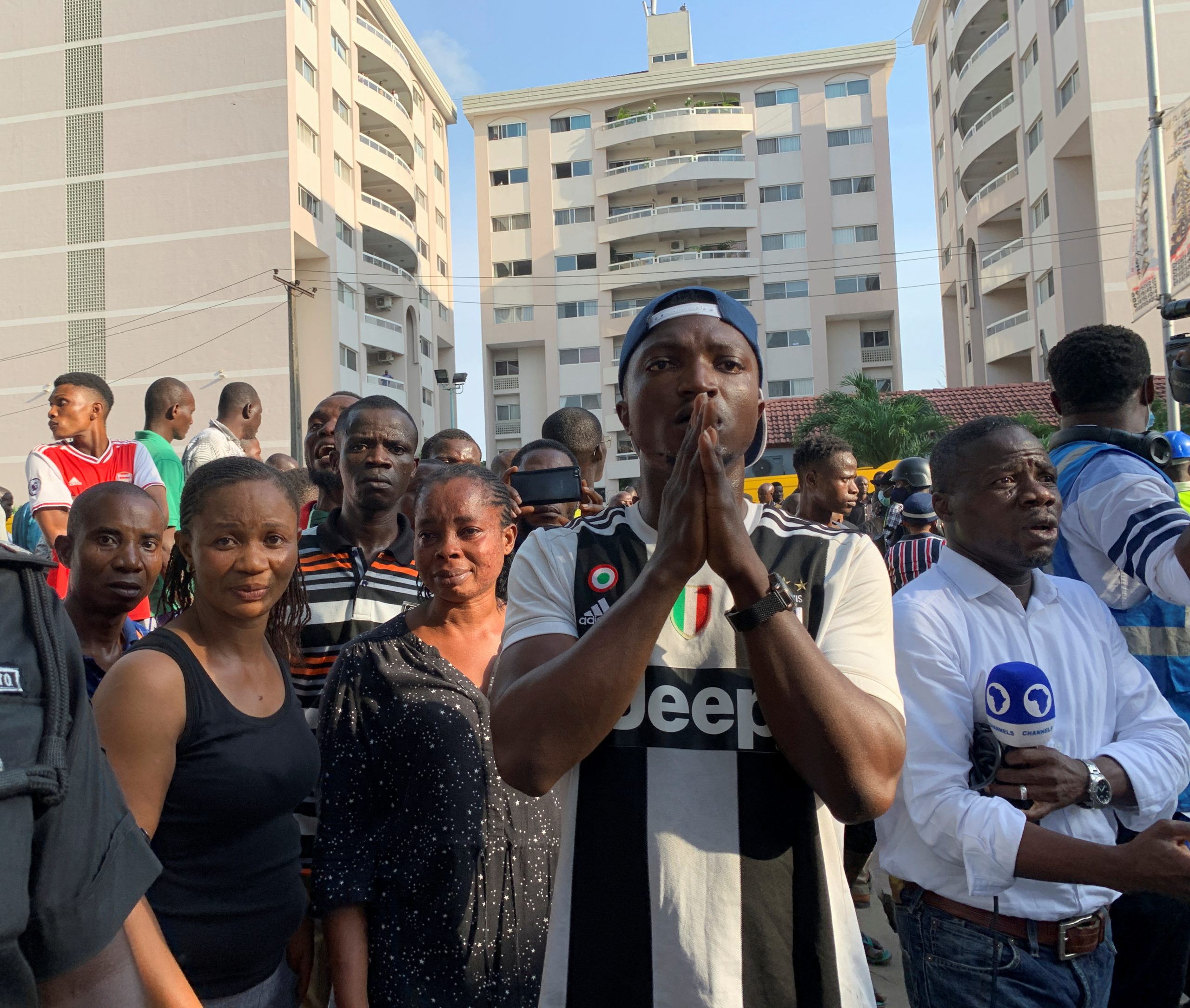 People gather at the site of a collapsed building in Ikoyi, Lagos
