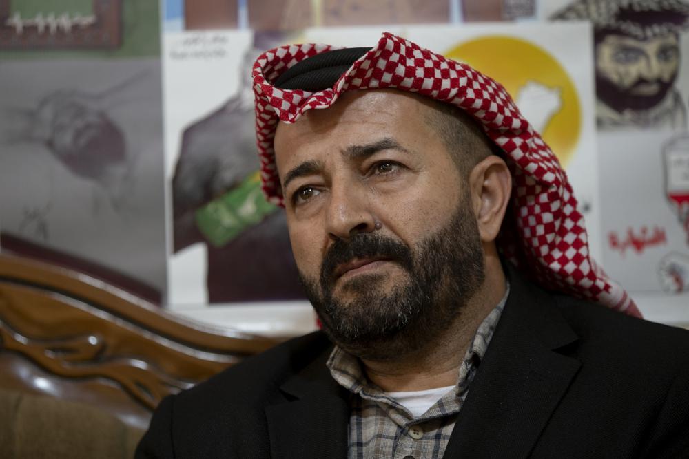 Former Palestinian prisoner Maher al-Akhras, poses for a photo, a year after being released from an Israeli prison following a 103-day hunger strike, at his house in the West Bank village of Silat Al-Dahar, Wednesday, Dec. 1, 2021. Palestinian prisoners have long used hunger strikes to pressure Israel to improve the conditions of their detention or to secure their release after being held without charges for months or years under a policy known as administrative detention. (AP Photo/Majdi Mohammed)