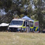 Emergency services personnel work the scene of a deadly incident involved with a bouncy castle at the Hillcrest Primary School in Devonport, Tasmania, Thursday, Dec. 16, 2021. Multiple children have died and others are in critical condition after falling from a bouncy castle that was lifted 10 meters (33 feet) into the air by a gust of wind at a junior school on the island state of Tasmania on Thursday. (Grant Wells/AAP Image via AP)