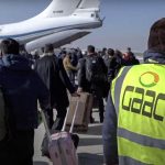 In this photo released by the Russian Defense Ministry Press Service, passengers gather to board Russian Military Il-76 cargo planes at the airport in Kabul, Afghanistan, Saturday, Dec. 18, 2021. Russian military transport planes have delivered a shipment of humanitarian supplies to Afghanistan and flew back 200 Russians, Afghan students and others. The Russian Defense Ministry said that three Il-76 cargo planes will make stopover in Tajikistan and Kyrgyzstan before flying to Moscow. (Russian Defense Ministry Press Service via AP)