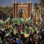 Demonstrators march holding banners and shouting slogans demanding the use of Catalan in schools of Catalonia, in Barcelona, Spain, Saturday, Dec. 18, 2021. Thousands of Catalans took to the streets of Barcelona on Saturday to protest a court decision that mandates a quarter of all classes in schools be taught in Spanish, as opposed to the local Catalan language. Placard reads in Catalan “Now and always, school must be in Catalan”. (AP Photo/Emilio Morenatti)