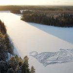 A drawing of a fox is seen on the frozen Pitkajarvi lake north of Helsinki, Finland, Saturday, Dec. 4, 2021. An architect-designer in southern Finland has returned to a frozen lake with a snow shovel to draw a large animal on the ice for the sixth year in a row to create a short-lived artwork that he hopes will “make people happy and encourage them to go out to hike in a beautiful nature.” The size of the figure on the ice is about 90 meters (295.3 feet) from edge to edge. (Pasi Widgren via AP)