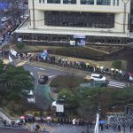 People wait for the coronavirus testing outside a public health center in Seoul, South Korea, Wednesday, Dec. 15, 2021. Halting its steps toward normalcy, South Korea will clamp down on social gatherings and cut the hours of some businesses to fight a record-breaking surge of the coronavirus that has led to a spike in hospitalizations and deaths. (AP Photo/Ahn Young-joon).