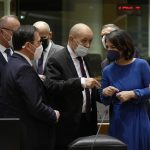 French Foreign Minister Jean-Yves Le Drian, center left, speaks with German Foreign Minister Annalena Baerbock, second right, during a meeting of EU foreign ministers at the European Council building in Brussels on Monday, Dec. 13, 2021. European Union foreign ministers met Monday to discuss how to thwart the threat of a possible new Russian invasion of Ukraine and what measures to take should Moscow decide to send its troops across the border. (AP Photo/Virginia Mayo)