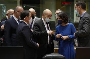 French Foreign Minister Jean-Yves Le Drian, center left, speaks with German Foreign Minister Annalena Baerbock, second right, during a meeting of EU foreign ministers at the European Council building in Brussels on Monday, Dec. 13, 2021. European Union foreign ministers met Monday to discuss how to thwart the threat of a possible new Russian invasion of Ukraine and what measures to take should Moscow decide to send its troops across the border. (AP Photo/Virginia Mayo)