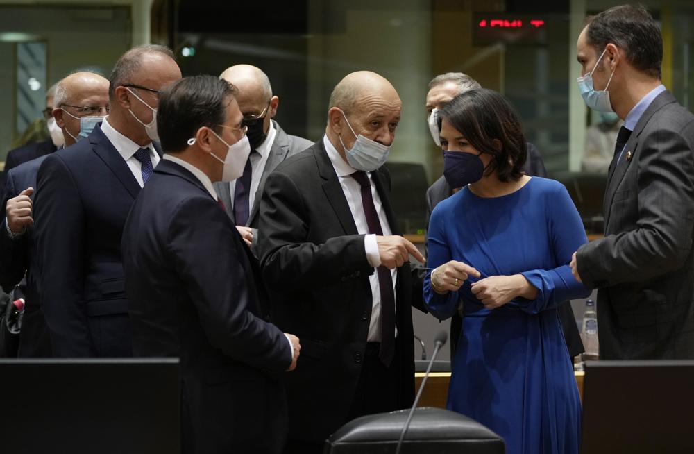 French Foreign Minister Jean-Yves Le Drian, center left, speaks with German Foreign Minister Annalena Baerbock, second right, during a meeting of EU foreign ministers at the European Council building in Brussels on Monday, Dec. 13, 2021. European Union foreign ministers met Monday to discuss how to thwart the threat of a possible new Russian invasion of Ukraine and what measures to take should Moscow decide to send its troops across the border. (AP Photo/Virginia Mayo)
